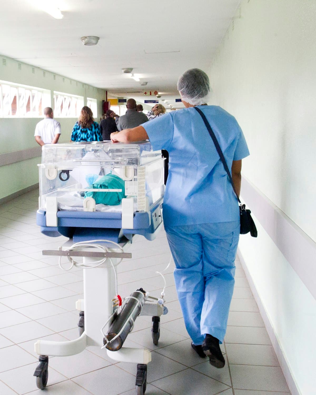 A clinician walking a hospital corridor.