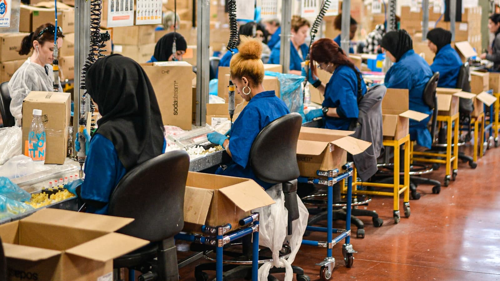 Workers assembling and packing on a production line.